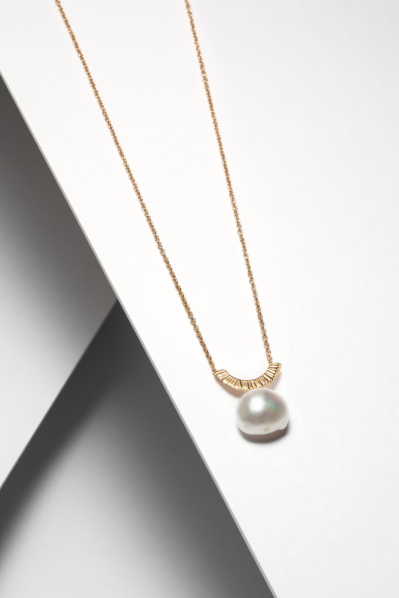 gold necklace with a pearl