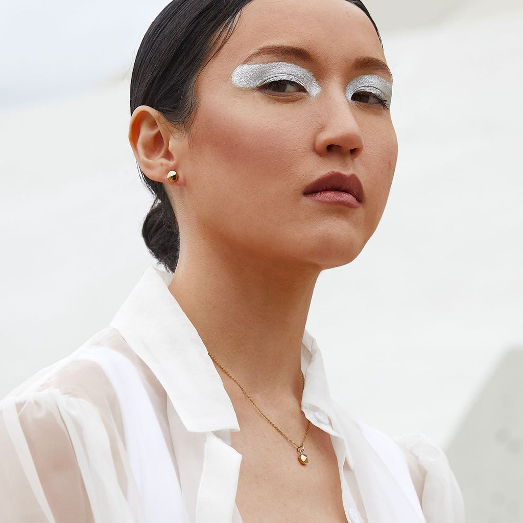 Small round faceted gold earrings by Canadian designer and jeweller Veronique Roy Jwls