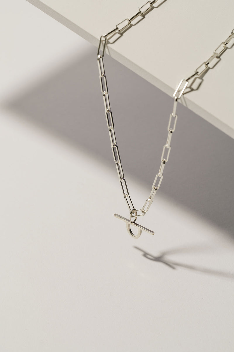 silver paperclip chain necklace with minimalist edgy charm