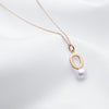 Oval shaped gold pendant necklace with freshwater pearl