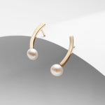 Gold plated curved bar and pearl stud earrings