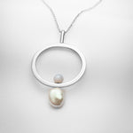 Long silver necklace with oblong pendant, a big pearl and blue lace agate stone