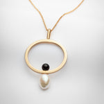 Gold oval pendant on long chain with black onyx and big pearl