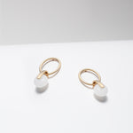 Gold plated hoop earrings with dangling white jade stone