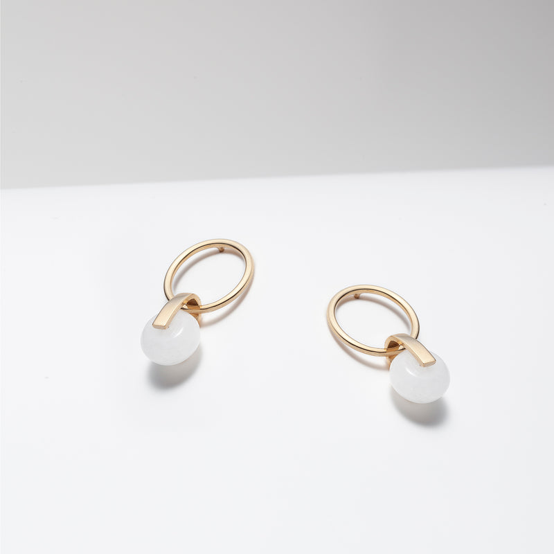 Gold plated hoop earrings with dangling white jade stone